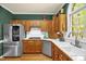 Charming kitchen with wood cabinets, stainless steel appliances, and a bright window at 2925 Ericka Dr, Hillsborough, NC 27278