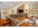 Bright living room with vaulted ceiling, stone fireplace, and view of the pool at 2925 Ericka Dr, Hillsborough, NC 27278