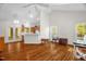 Bright living room with hardwood floors, white walls, and a view into the kitchen and backyard at 2925 Ericka Dr, Hillsborough, NC 27278