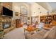 Cozy living room with stone fireplace, vaulted ceilings, large windows, and comfortable seating, creating a warm atmosphere at 2925 Ericka Dr, Hillsborough, NC 27278