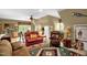Cozy living area featuring a red loveseat, ceiling fan, and decoratively patterned area rug at 2925 Ericka Dr, Hillsborough, NC 27278