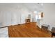 Open floor plan living room with hardwood floors, white walls, and adjacent counter at 2925 Ericka Dr, Hillsborough, NC 27278