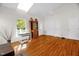 Bright living room with hardwood floors, white walls, skylight, and adjacent shelving and table at 2925 Ericka Dr, Hillsborough, NC 27278