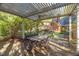 Covered patio with outdoor dining set, grill, fireplace, and backyard views at 2925 Ericka Dr, Hillsborough, NC 27278