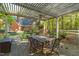 Charming outdoor patio featuring a pergola, brick pavers, and a dining set for outdoor entertaining at 2925 Ericka Dr, Hillsborough, NC 27278
