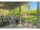 An inviting porch view showcases seating, greenery, and natural light, with beautiful views of the surrounding landscape at 2925 Ericka Dr, Hillsborough, NC 27278