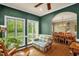 Sitting room with hardwood floors, large windows overlooking greenery, and a comfortable chair at 2925 Ericka Dr, Hillsborough, NC 27278