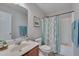 Bright bathroom with a shower and tub combination, complemented by a tasteful patterned shower curtain at 3114 Courtney Creek Blvd, Durham, NC 27713