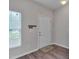 Neat foyer with wood-look flooring, a white door, and simple decor for an inviting entrance at 3114 Courtney Creek Blvd, Durham, NC 27713