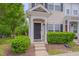 Inviting entryway with a black front door, small porch, and manicured bushes enhancing curb appeal at 3114 Courtney Creek Blvd, Durham, NC 27713