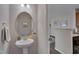Chic half bathroom with modern fixture, stylish oval mirror, and neutral tones for a clean look at 3114 Courtney Creek Blvd, Durham, NC 27713