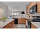 Open kitchen view with black appliances, light countertops, and an island opening to the living space at 3114 Courtney Creek Blvd, Durham, NC 27713