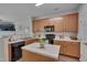 Well-lit kitchen featuring modern appliances, light countertops, and ample cabinet space for storage at 3114 Courtney Creek Blvd, Durham, NC 27713