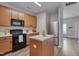 Functional kitchen with stainless steel appliances, light wood cabinets, and an island at 3114 Courtney Creek Blvd, Durham, NC 27713