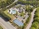 Aerial view of community tennis courts and a swimming pool surrounded by lush greenery and trees at 3302 Colorcott St, Raleigh, NC 27614