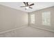 This bedroom has neutral paint, carpet and a ceiling fan, plus two windows for plenty of natural light at 3302 Colorcott St, Raleigh, NC 27614