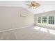 Bright bedroom with vaulted ceiling, ceiling fan, and large windows overlooking backyard at 3302 Colorcott St, Raleigh, NC 27614