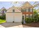 Charming two-story home with a brick facade, two-car garage, well-maintained lawn, and a cheerful, welcoming entrance at 3302 Colorcott St, Raleigh, NC 27614