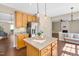 Open-concept kitchen with island, pendant lighting, stainless steel appliances, and eat in dining at 3302 Colorcott St, Raleigh, NC 27614