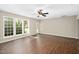 Large living room with a ceiling fan and multiple windows providing ample natural light at 3302 Colorcott St, Raleigh, NC 27614