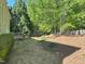 Large backyard area, with a wooden deck attached to the house, and plenty of trees nearby at 3316 Belspring Ln, Raleigh, NC 27612