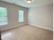 Comfortable bedroom featuring plush carpet, and two windows for abundant natural lighting at 3316 Belspring Ln, Raleigh, NC 27612
