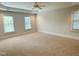 Spacious carpeted bedroom with three windows and a ceiling fan at 3316 Belspring Ln, Raleigh, NC 27612