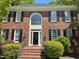 Charming brick home featuring a grand entrance with a large arched window at 3316 Belspring Ln, Raleigh, NC 27612