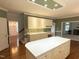 Bright kitchen with an island and lots of white cabinets for extra storage at 3316 Belspring Ln, Raleigh, NC 27612