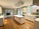 Open kitchen with white cabinets, island, and ample counter space with backyard view at 3316 Belspring Ln, Raleigh, NC 27612