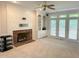 Carpeted living room with a brick fireplace and large built-in bookshelf at 3316 Belspring Ln, Raleigh, NC 27612