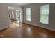 Bright living room featuring hardwood floors and natural light from multiple windows at 3316 Belspring Ln, Raleigh, NC 27612