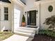 Inviting front entrance with an ornate door, stylish lighting, and well-kept landscaping at 3332 Langston Cir, Apex, NC 27539