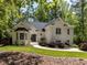 Charming white brick home featuring lush landscaping and a welcoming walkway at 3332 Langston Cir, Apex, NC 27539