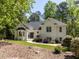 Charming white brick home with manicured landscaping, a walkway leading to the front door, and mature trees at 3332 Langston Cir, Apex, NC 27539