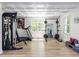 Spacious home gym features workout machines, weights, and large windows providing natural light at 3332 Langston Cir, Apex, NC 27539