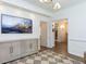View of hallway with hardwood floors, white walls, and cabinet with artwork above at 3332 Langston Cir, Apex, NC 27539