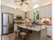 Bright kitchen features granite countertops, stainless steel appliances, and a large window with wooded views at 3332 Langston Cir, Apex, NC 27539