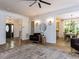 Welcoming living room features hardwood floors, a ceiling fan, a rug, and a view to the dining room at 3332 Langston Cir, Apex, NC 27539