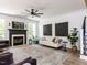 Bright living room with a fireplace, hardwood floors, and stylish decor at 3332 Langston Cir, Apex, NC 27539