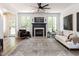 Elegant living room featuring a fireplace, large windows, and comfortable seating at 3332 Langston Cir, Apex, NC 27539