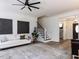 Spacious living room with a fireplace, hardwood floors, and access to other areas at 3332 Langston Cir, Apex, NC 27539