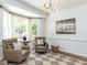 Sitting room with large bay windows, chairs, and neutral tones at 3332 Langston Cir, Apex, NC 27539