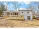 View of a backyard with a deck and screened in porch on a white exterior home at 3408 Brentwood Rd, Raleigh, NC 27604