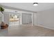 A basement living area featuring light, vinyl floors, and a sliding glass door at 3408 Brentwood Rd, Raleigh, NC 27604
