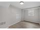 Finished basement area with a window and light hardwood floors at 3408 Brentwood Rd, Raleigh, NC 27604