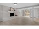 Finished basement with painted brick fireplace and sliding glass door at 3408 Brentwood Rd, Raleigh, NC 27604