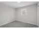 Neutral bedroom with gray carpet, white trim and a window at 3408 Brentwood Rd, Raleigh, NC 27604