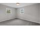Neutral bedroom showcasing two windows and plush carpeting at 3408 Brentwood Rd, Raleigh, NC 27604
