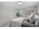 Bedroom featuring a neutral color palette, cozy bedding, and indoor plant at 3408 Brentwood Rd, Raleigh, NC 27604